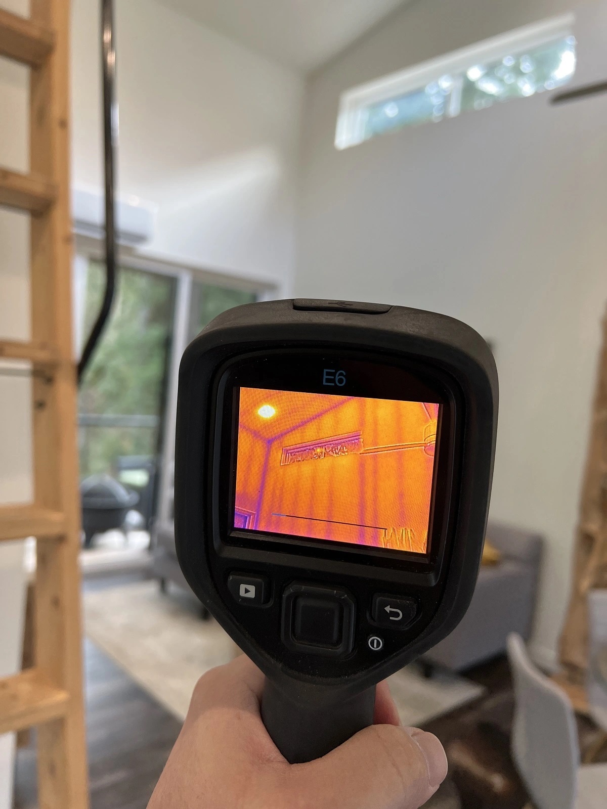 Home inspector Abbotsford using thermal imaging camera during crawl space moisture inspection